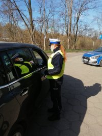 policjanci rozdają maseczki na ulicach Łodzi