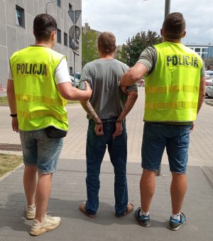 Policjanci konwojują sprawce zbójstwa