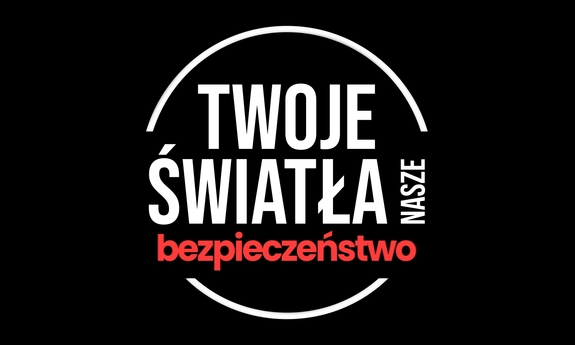 Plakat profilaktyczny w kolorach białym, czerwonym i czarnym, z napisem Twoje światła nasze bezpieczeństwo.