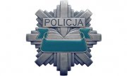 szara gwiazda policyjna, po środku , na niebieskim tle jest napis Policja.