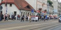 Pochód na ulicy Piotrkowskiej. Manifestujący zmierzają w stronę Katedry.