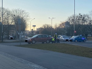 Policjanci naprawiają samochód kobiety.