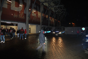 Kibicie po wyjściu z meczu, opuszczają stadion. W tle policjanci.