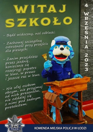 Kot Prewencjusz , maskotka łódzkiej policji siedzi w szkolnej ławce na tle plakatu z poradami dotyczącymiobezpieczeństwa.