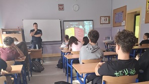 Policjant w klasie, w trakcie zajęć z młodzieżą.