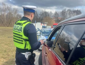 Policjant Wydziału Ruchu Drogowego Komendy Miejskiej Policji w Łodzi w trakcie kontroli drogowej.