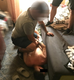 Policjanci zatrzymują podejrzanego.